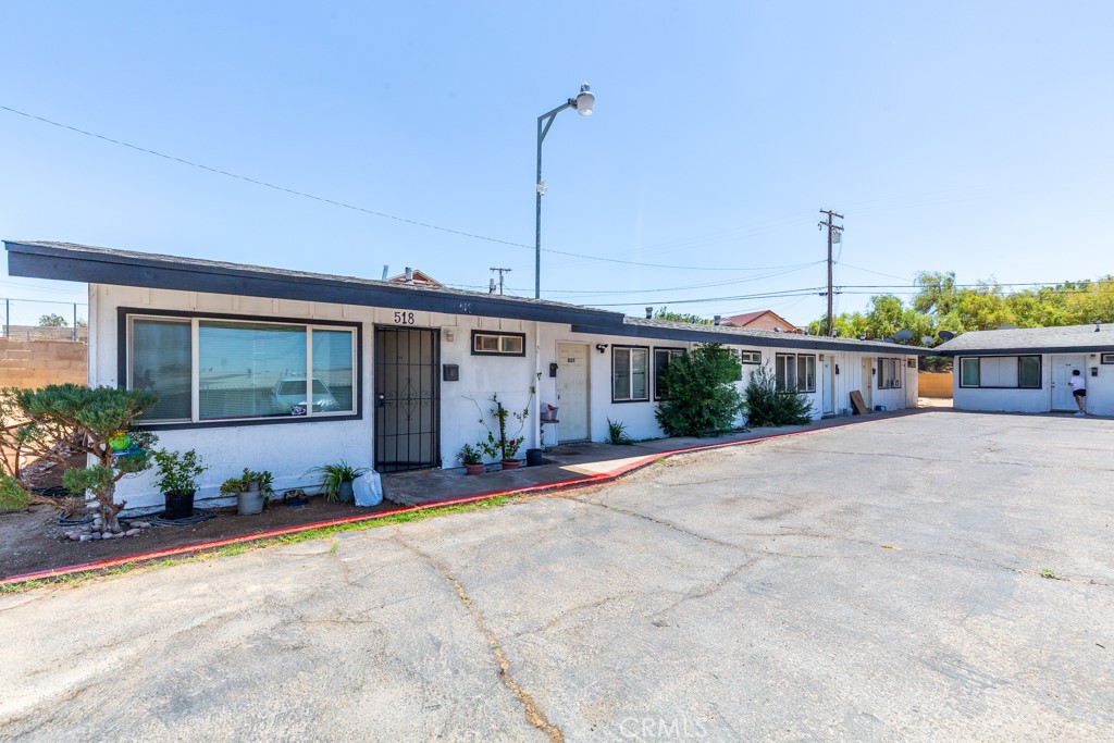 518 West Fredricks Street Barstow, CA 92311 - Photo 6 of 35 a front view of a house with a yard and potted plants