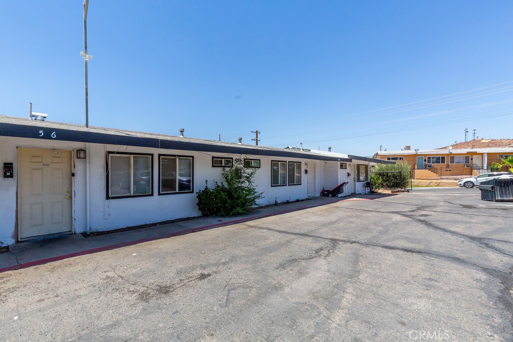 518 West Fredricks Street Barstow, CA 92311 - Photo 9 of 35 a front view of a house with a yard and garage