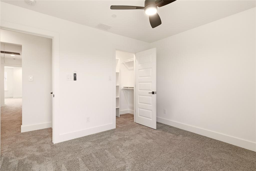 8909 Lowell Street Rowlett, TX 75089 - Photo 12 of 25 Unfurnished bedroom featuring carpet floors, a spacious closet, and ceiling fan