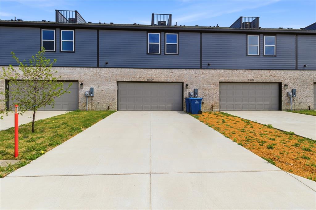 8909 Lowell Street Rowlett, TX 75089 - Photo 23 of 25 View of front of property with concrete driveway and a garage
