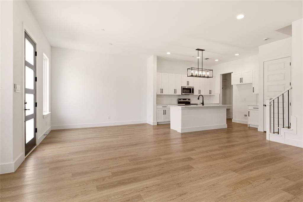 8909 Lowell Street Rowlett, TX 75089 - Photo 5 of 25 Unfurnished living room featuring light wood-style flooring and recessed lighting