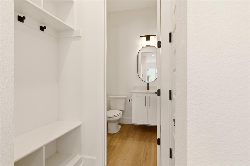 8909 Lowell Street Rowlett, TX 75089 - Photo 7 of 25 Bathroom with vanity, light wood-type flooring, and a textured wall