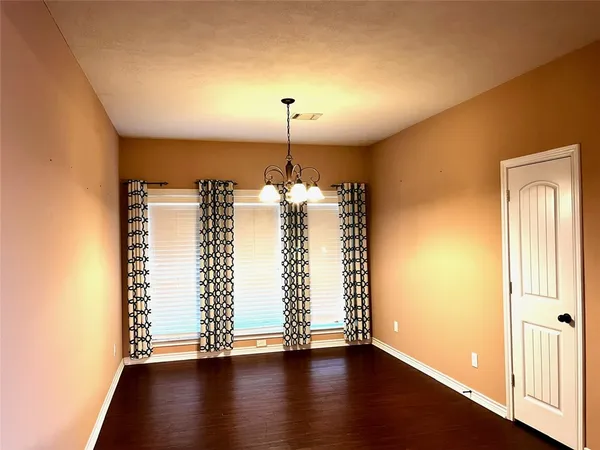 a view of a room with wooden floor closet and a window