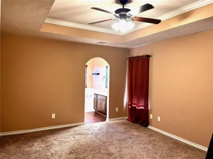 a view of an empty room with a ceiling fan