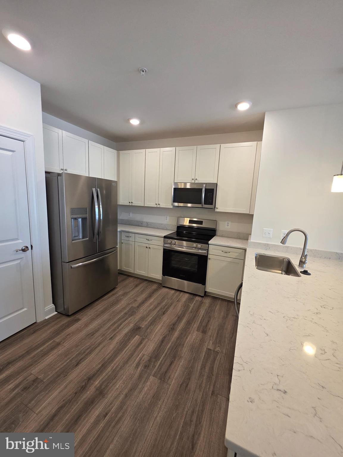 404 Bold Ruler Court, Unit 204 Havre de Grace, MD 21078 - Photo 19 of 31 a kitchen with stainless steel appliances a refrigerator a sink a stove a microwave and cabinets