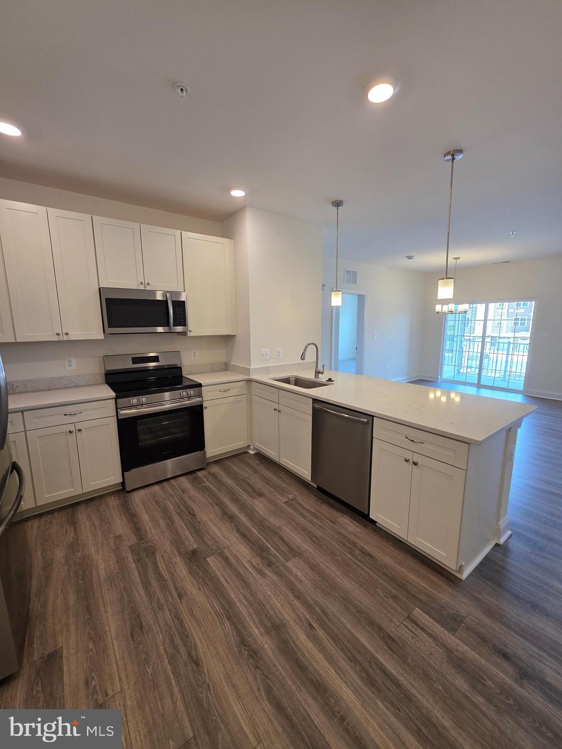 404 Bold Ruler Court, Unit 204 Havre de Grace, MD 21078 - Photo 20 of 31 a kitchen with wooden floors and white appliances