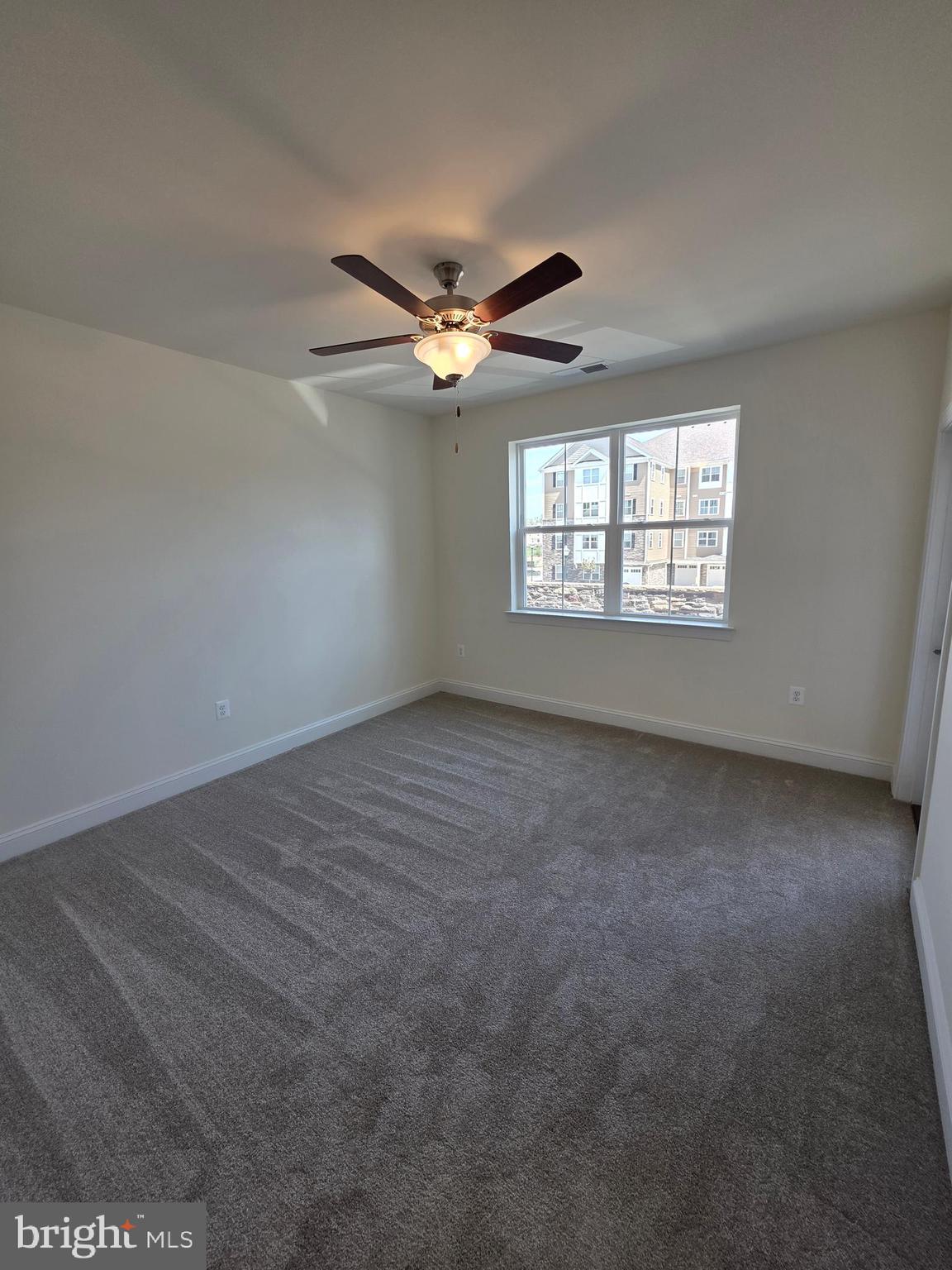 404 Bold Ruler Court, Unit 204 Havre de Grace, MD 21078 - Photo 24 of 31 en empty room with windows and ceiling fan
