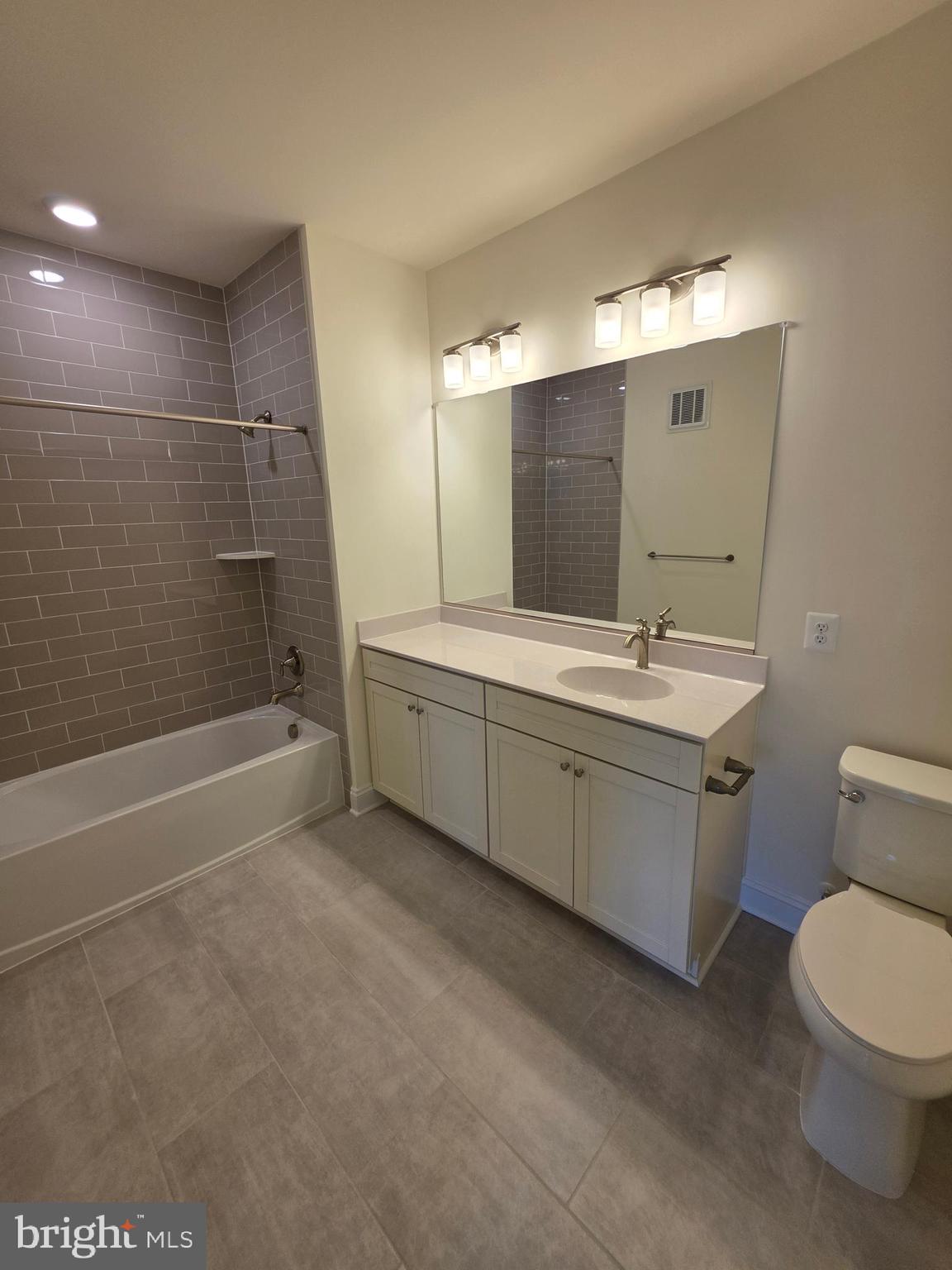 404 Bold Ruler Court, Unit 204 Havre de Grace, MD 21078 - Photo 30 of 31 a bathroom with a double vanity sink toilet and shower