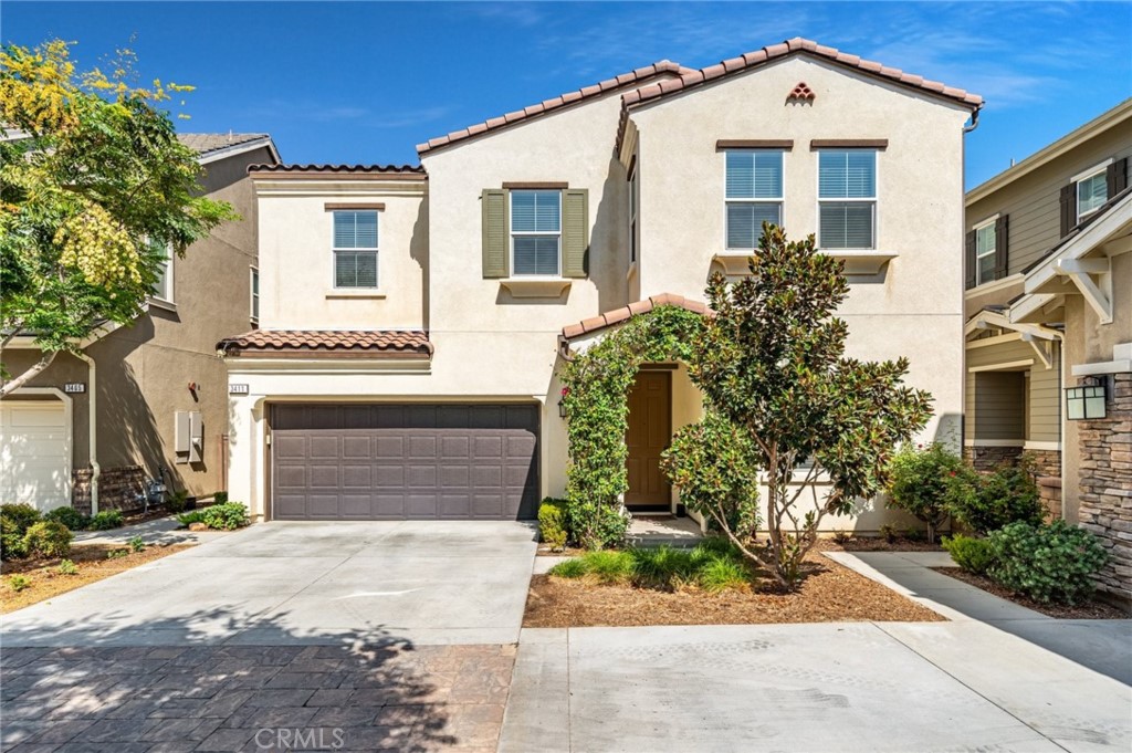 3411 Pine Ridge Loop Ontario, CA 91761 - Photo 1 of 1 a front view of a house with a yard and garage