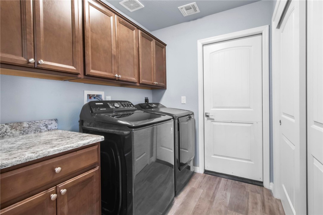 3897 Easy Street Kingman, AZ 86409 - Photo 16 of 53 a utility room with granite countertop cabinets washer and dryer