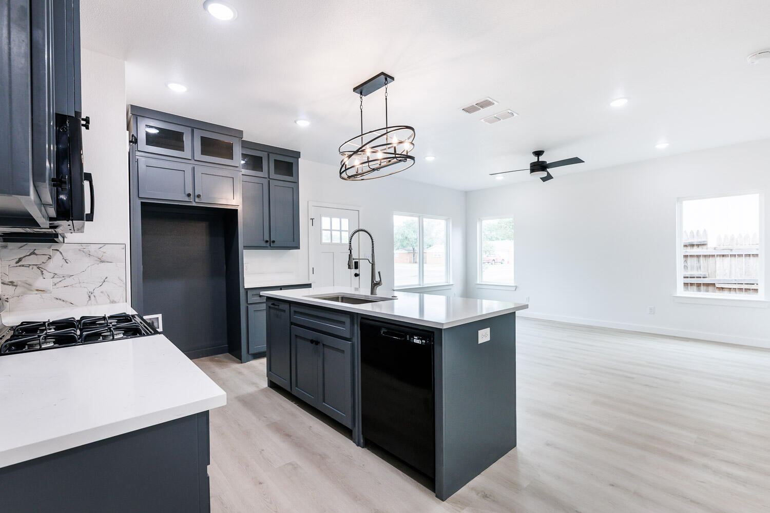 1704 Elkhart Avenue, Unit A Lubbock, TX 79416 - Photo 11 of 44 a kitchen with stainless steel appliances granite countertop a sink a stove and a refrigerator
