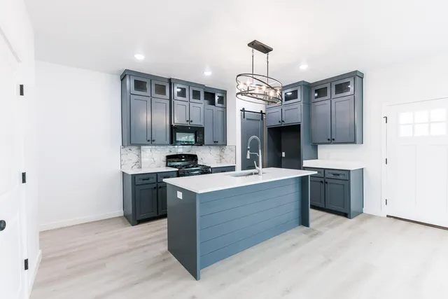 a kitchen with stainless steel appliances granite countertop a stove oven and a sink
