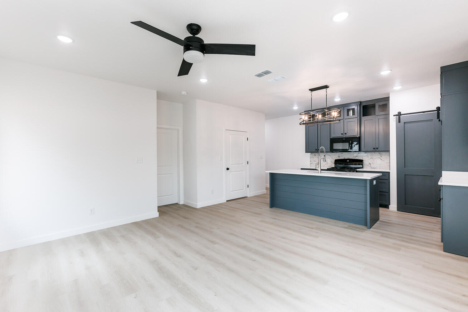 1704 Elkhart Avenue, Unit A Lubbock, TX 79416 - Photo 15 of 44 a kitchen with stainless steel appliances kitchen island granite countertop a refrigerator and a stove top oven