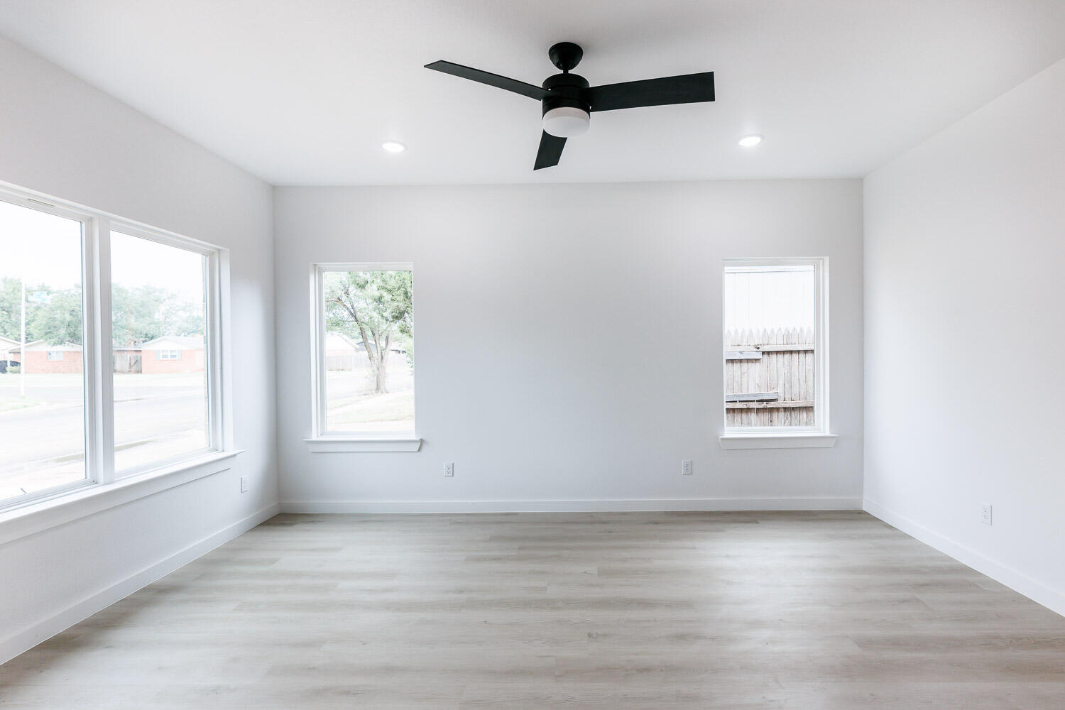 1704 Elkhart Avenue, Unit A Lubbock, TX 79416 - Photo 16 of 44 an empty room with a window and a ceiling fan