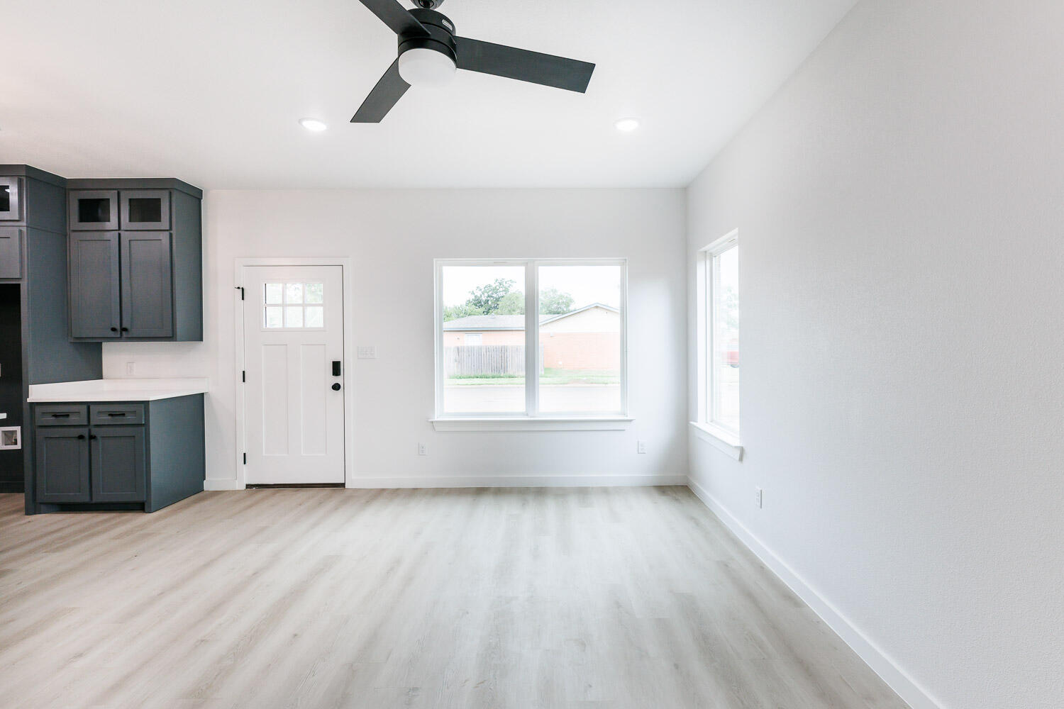 1704 Elkhart Avenue, Unit A Lubbock, TX 79416 - Photo 17 of 44 a view of an empty room with a window and a kitchen