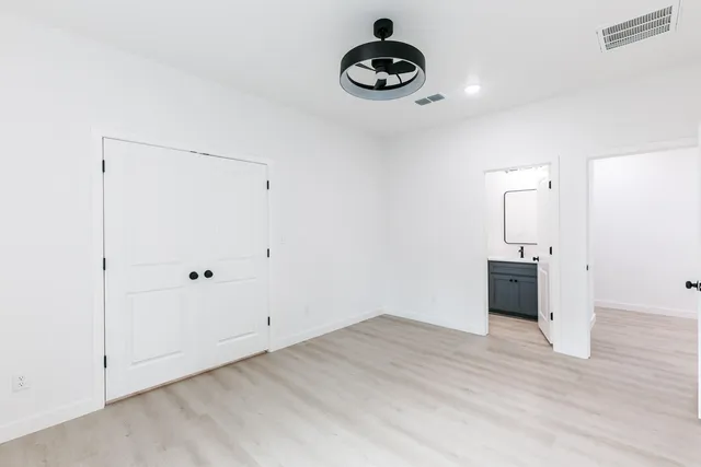 a view of an empty room with wooden floor