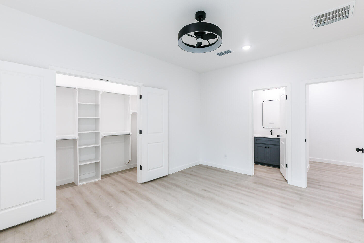 1704 Elkhart Avenue, Unit A Lubbock, TX 79416 - Photo 22 of 44 an empty room with wooden floor and windows