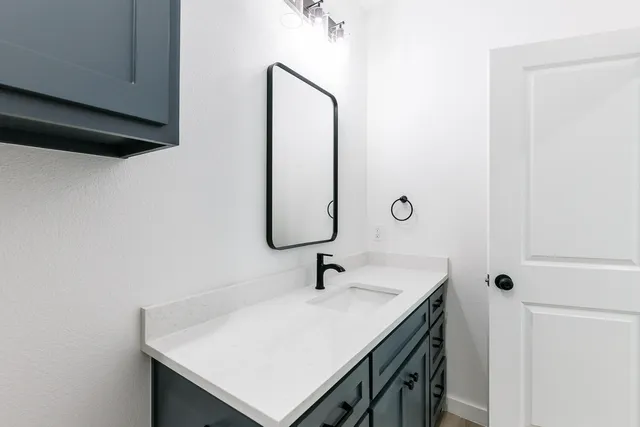 a bathroom with a sink a mirror and vanity
