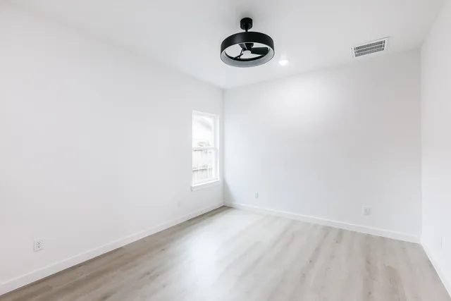 a view of wooden floor and a window