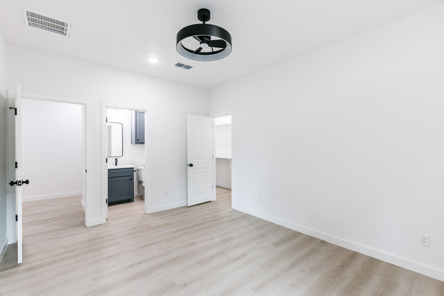 1704 Elkhart Avenue, Unit A Lubbock, TX 79416 - Photo 30 of 44 a view of an empty room with wooden floor and a window