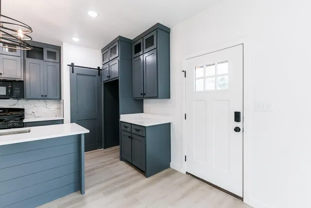 a kitchen with stainless steel appliances cabinets and a refrigerator