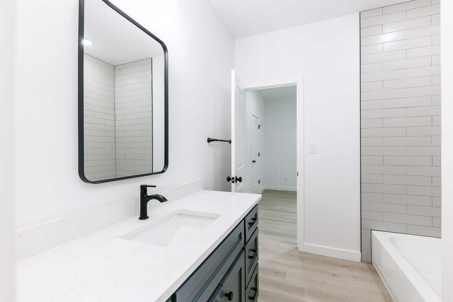 1704 Elkhart Avenue, Unit A Lubbock, TX 79416 - Photo 34 of 44 a bathroom with a sink and a bathtub