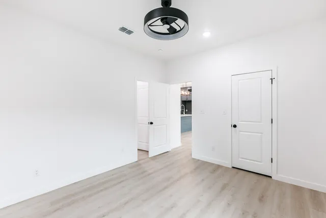 a view of a room with wooden floor