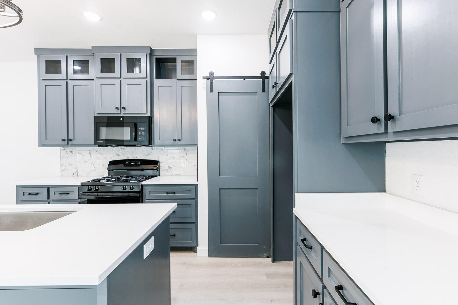1704 Elkhart Avenue, Unit A Lubbock, TX 79416 - Photo 4 of 44 a kitchen with a sink a microwave a refrigerator and cabinets