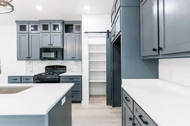 a kitchen with a sink a stove and refrigerator