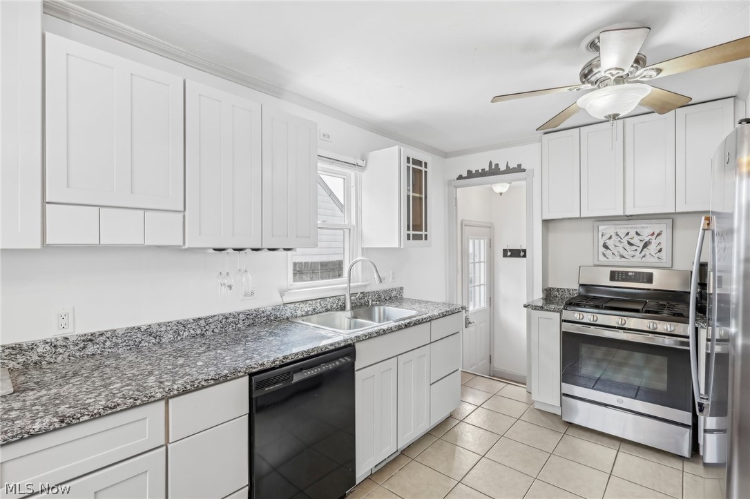 2709 Ralph Avenue Cleveland, OH 44109 - Photo 9 of 40 Kitchen with appliances with stainless steel finishes, a healthy amount of sunlight