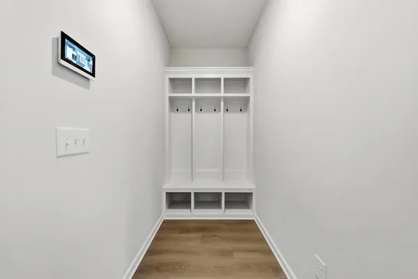 a view of a hallway with wooden floor and a window
