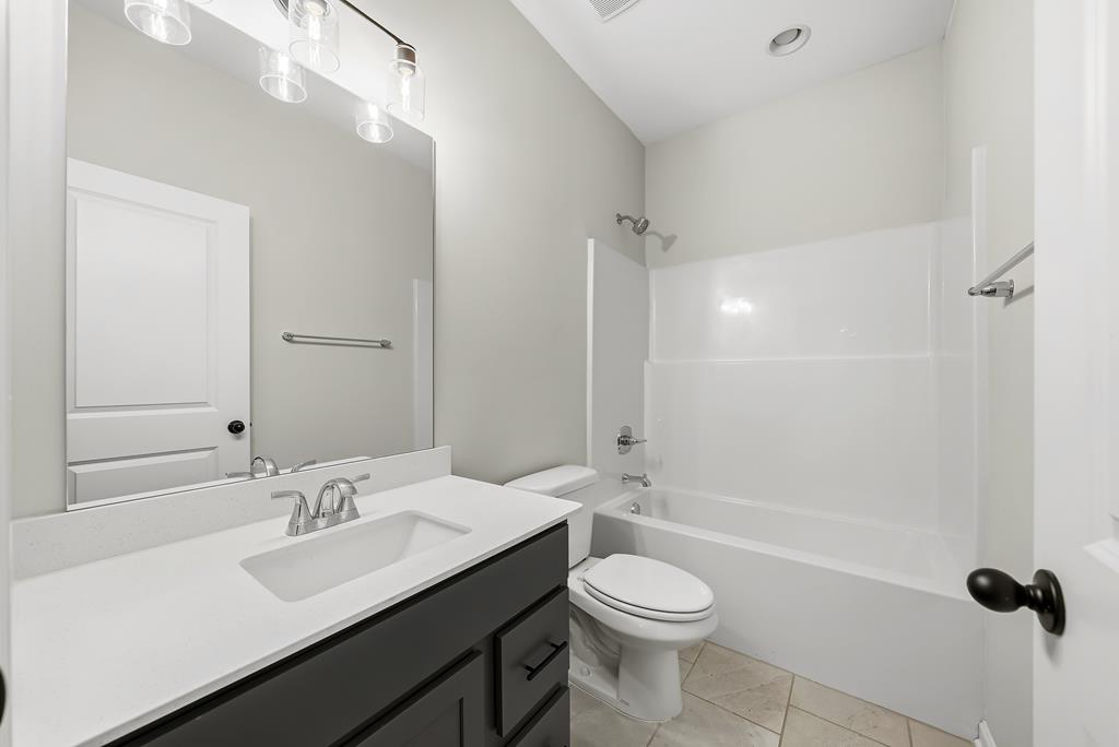 1304 McAlpine Ridge Auburn, AL 36830 - Photo 15 of 34 a bathroom with a sink a toilet and shower