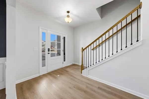 a view of an entryway with wooden floor