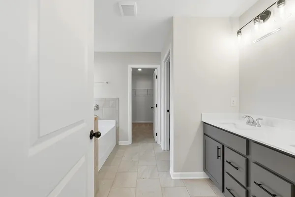 a bathroom with a bathtub and shower