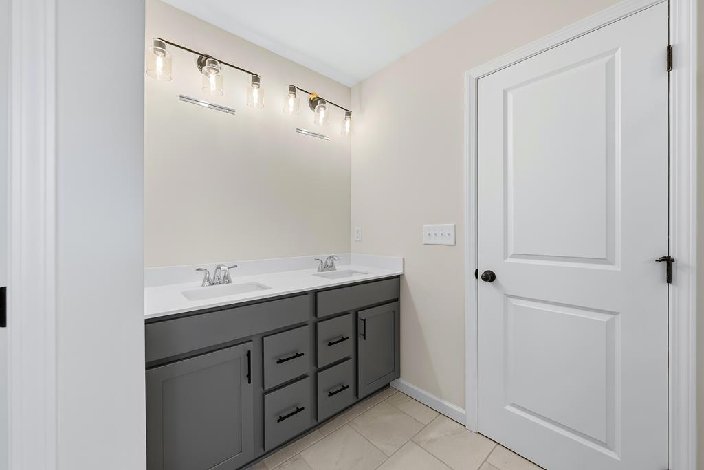 1304 McAlpine Ridge Auburn, AL 36830 - Photo 32 of 34 a bathroom with a double vanity sink and mirror