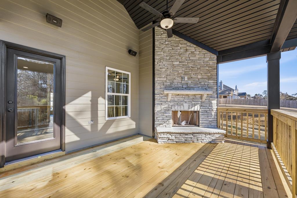 1304 McAlpine Ridge Auburn, AL 36830 - Photo 33 of 34 a view of a balcony with wooden floor and a fireplace