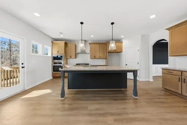 a living room with kitchen island furniture and a wooden floor