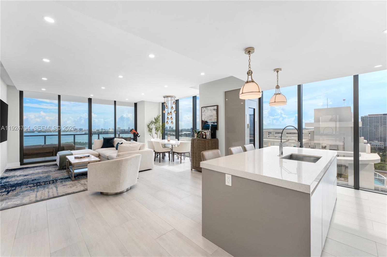 788 Northeast 23rd Street, Unit 2201 Miami, FL 33137 - Photo 1 of 29 a large room with lots of tables a large window and couch