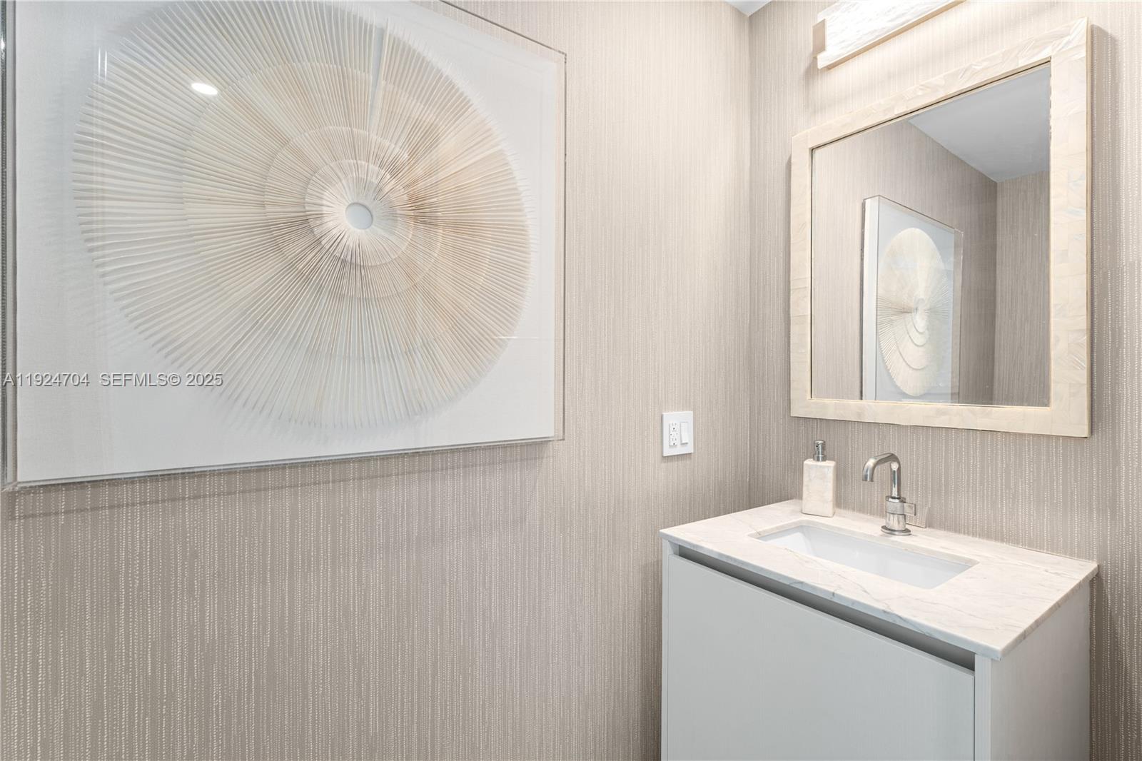 788 Northeast 23rd Street, Unit 2201 Miami, FL 33137 - Photo 11 of 29 a bathroom with a sink and a mirror