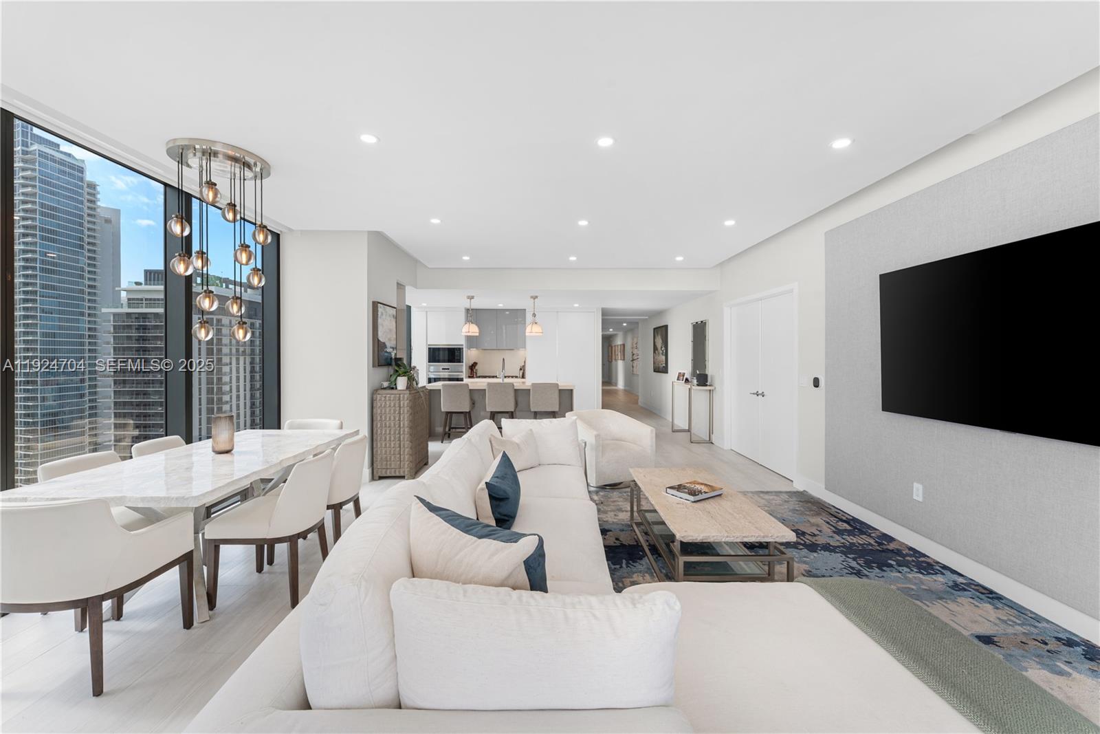 788 Northeast 23rd Street, Unit 2201 Miami, FL 33137 - Photo 3 of 29 a living room with furniture and a flat screen tv