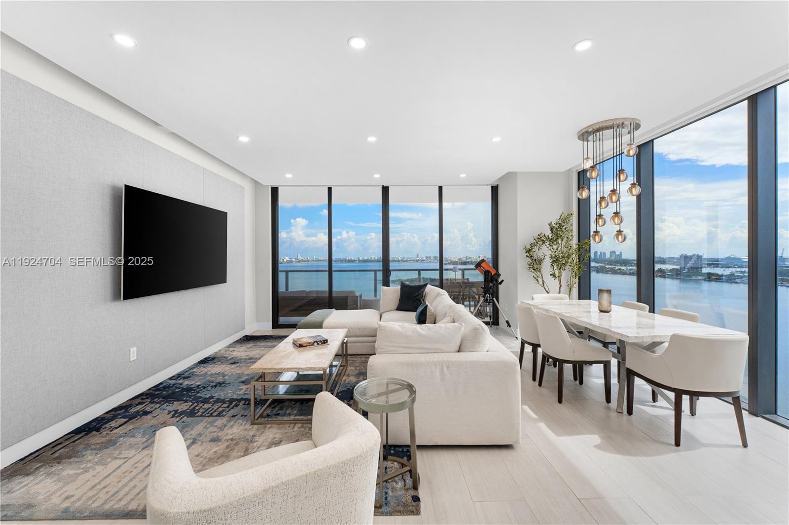 788 Northeast 23rd Street, Unit 2201 Miami, FL 33137 - Photo 4 of 29 a living room with furniture and a flat screen tv