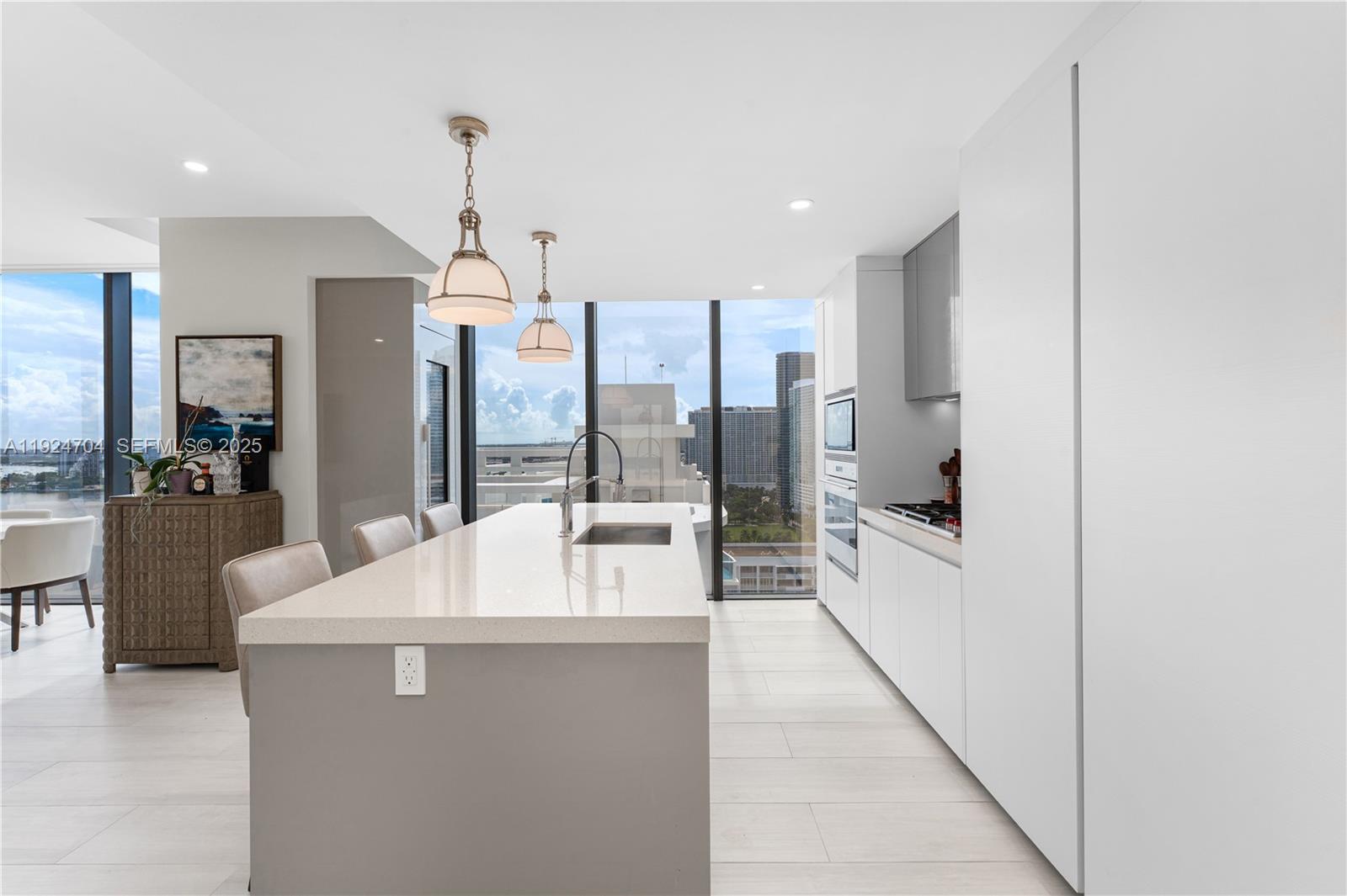 788 Northeast 23rd Street, Unit 2201 Miami, FL 33137 - Photo 7 of 29 a large white kitchen with a large window