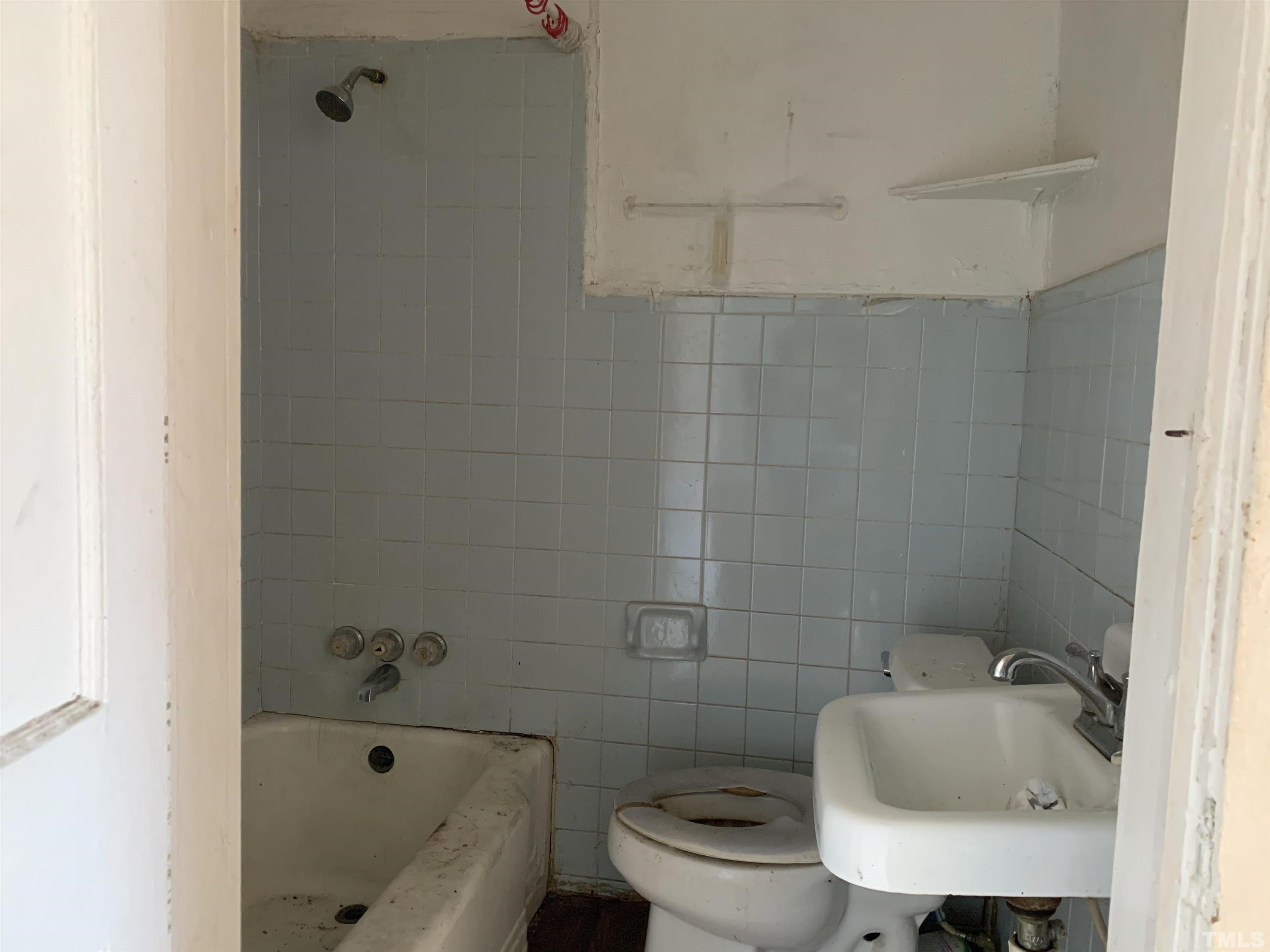 1311 South Person Street Raleigh, NC 27601 - Photo 11 of 18 a bathroom with a sink a toilet and bathtub