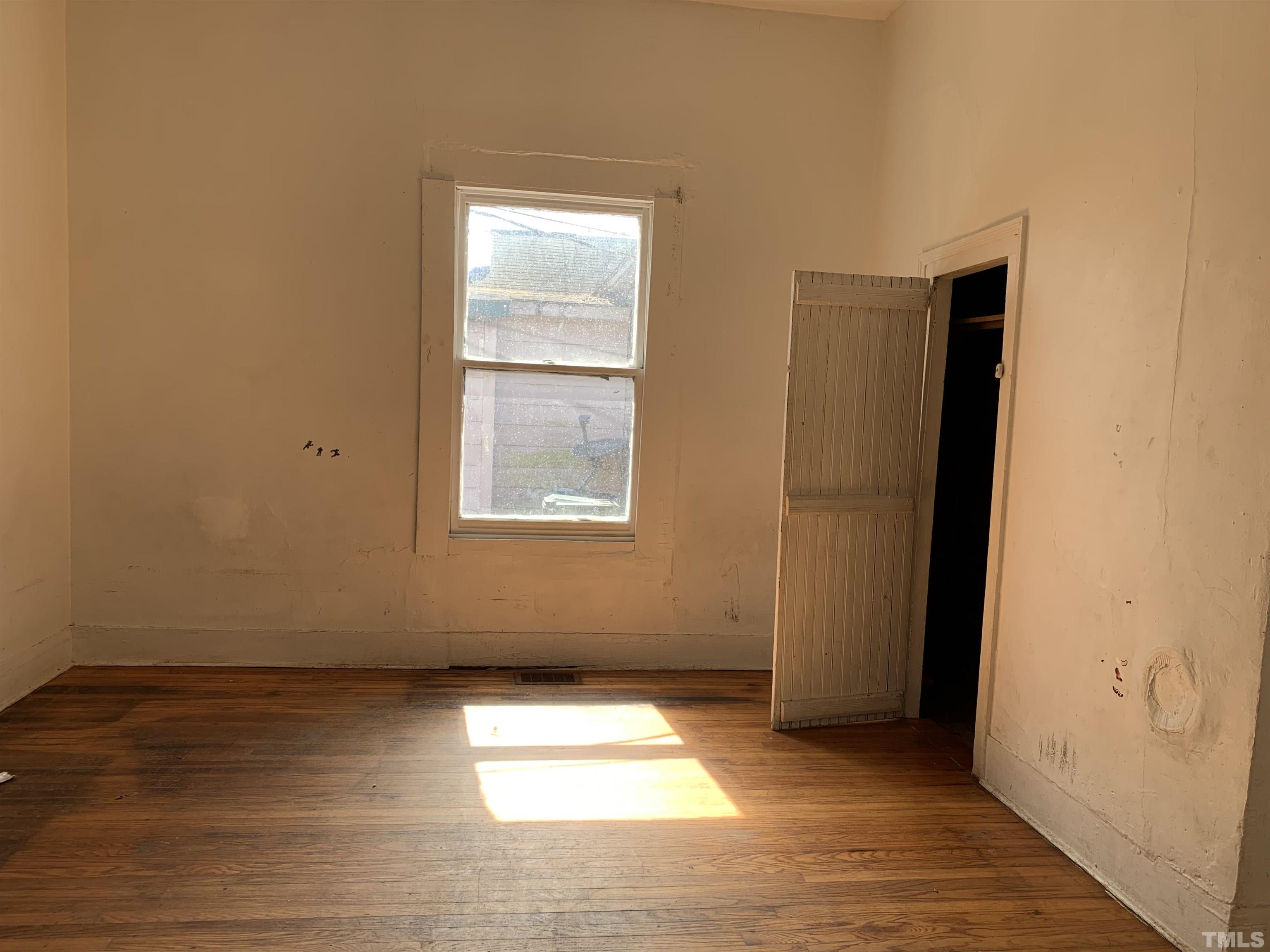1311 South Person Street Raleigh, NC 27601 - Photo 12 of 18 an empty room with wooden floor and windows