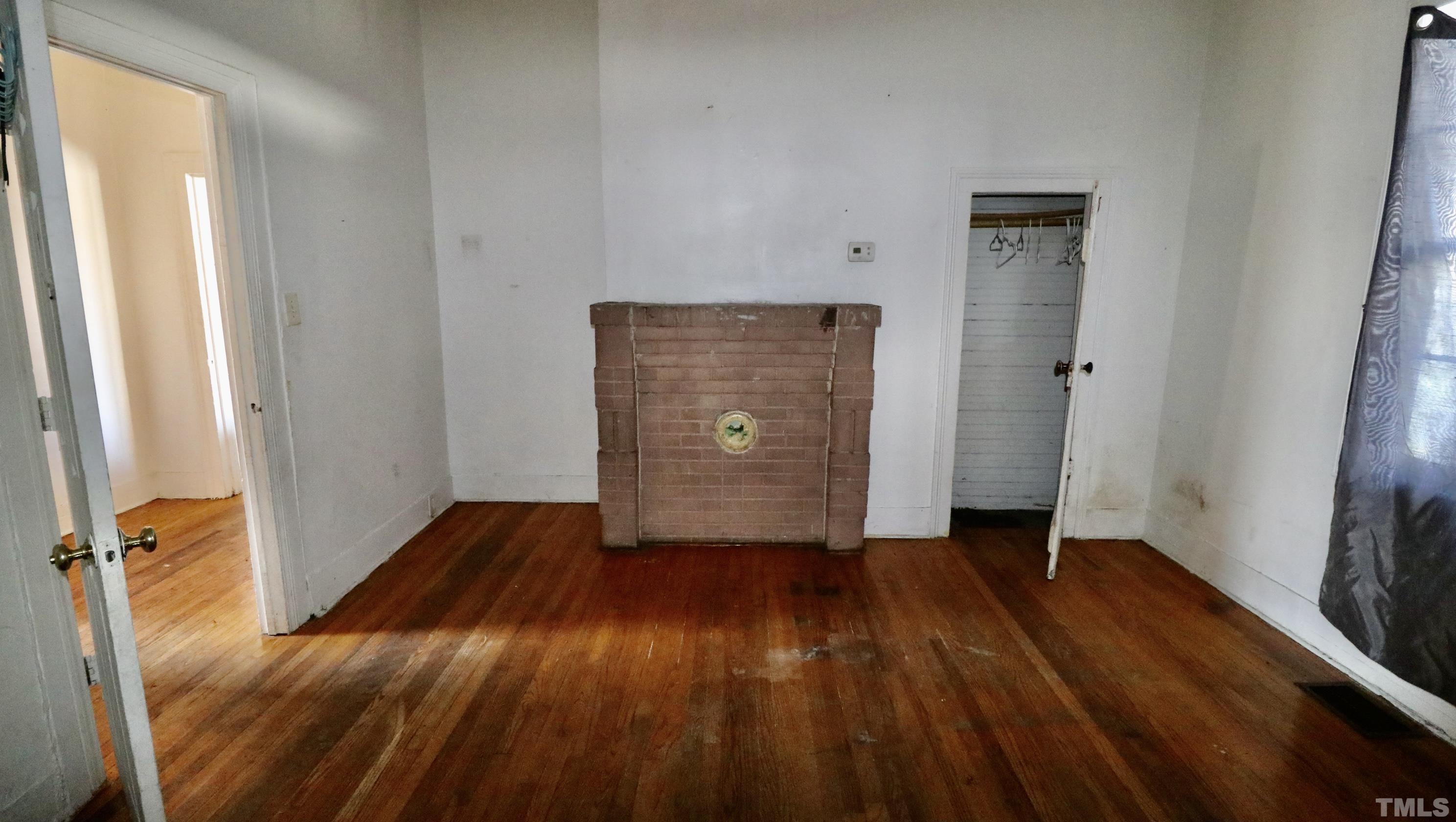 1311 South Person Street Raleigh, NC 27601 - Photo 4 of 18 a view of an empty room with wooden floor and a window