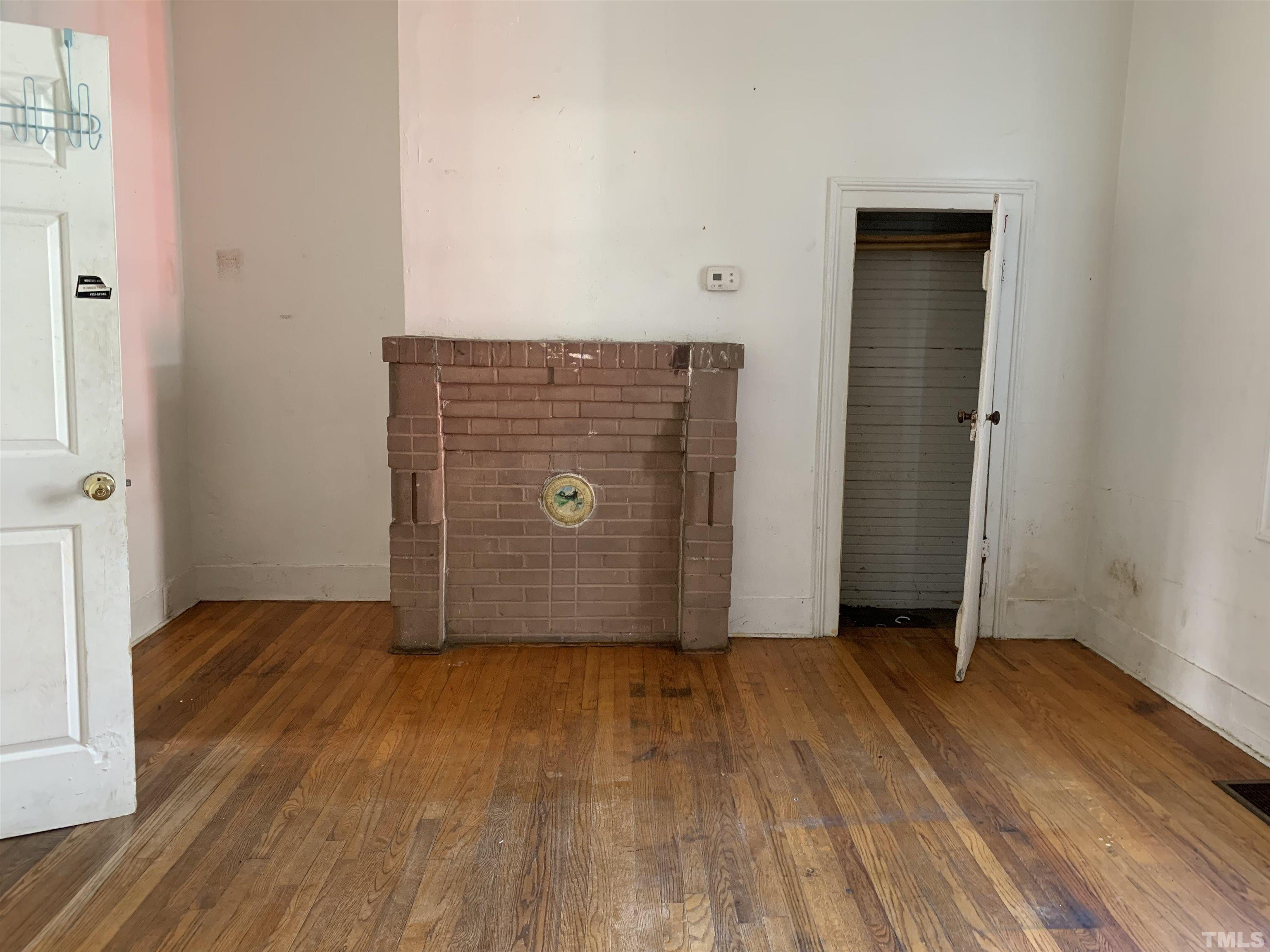 1311 South Person Street Raleigh, NC 27601 - Photo 10 of 18 a view of an empty room with wooden floor and a window