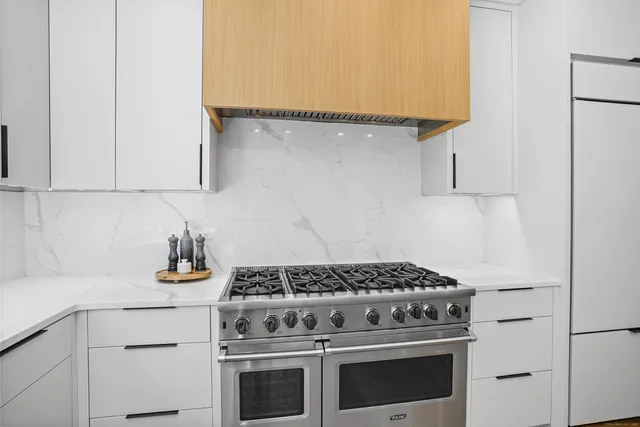 a stove top oven sitting inside of a kitchen