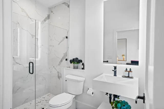 a bathroom with a sink toilet and shower