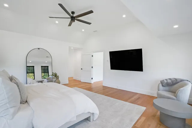 a bedroom with a bed and a flat screen tv