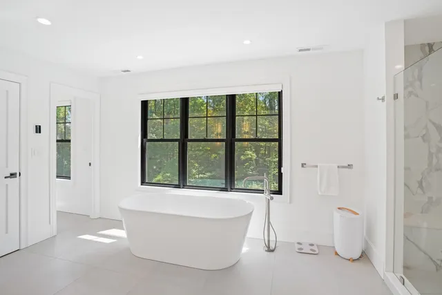 a living room with a large window and a bathtub